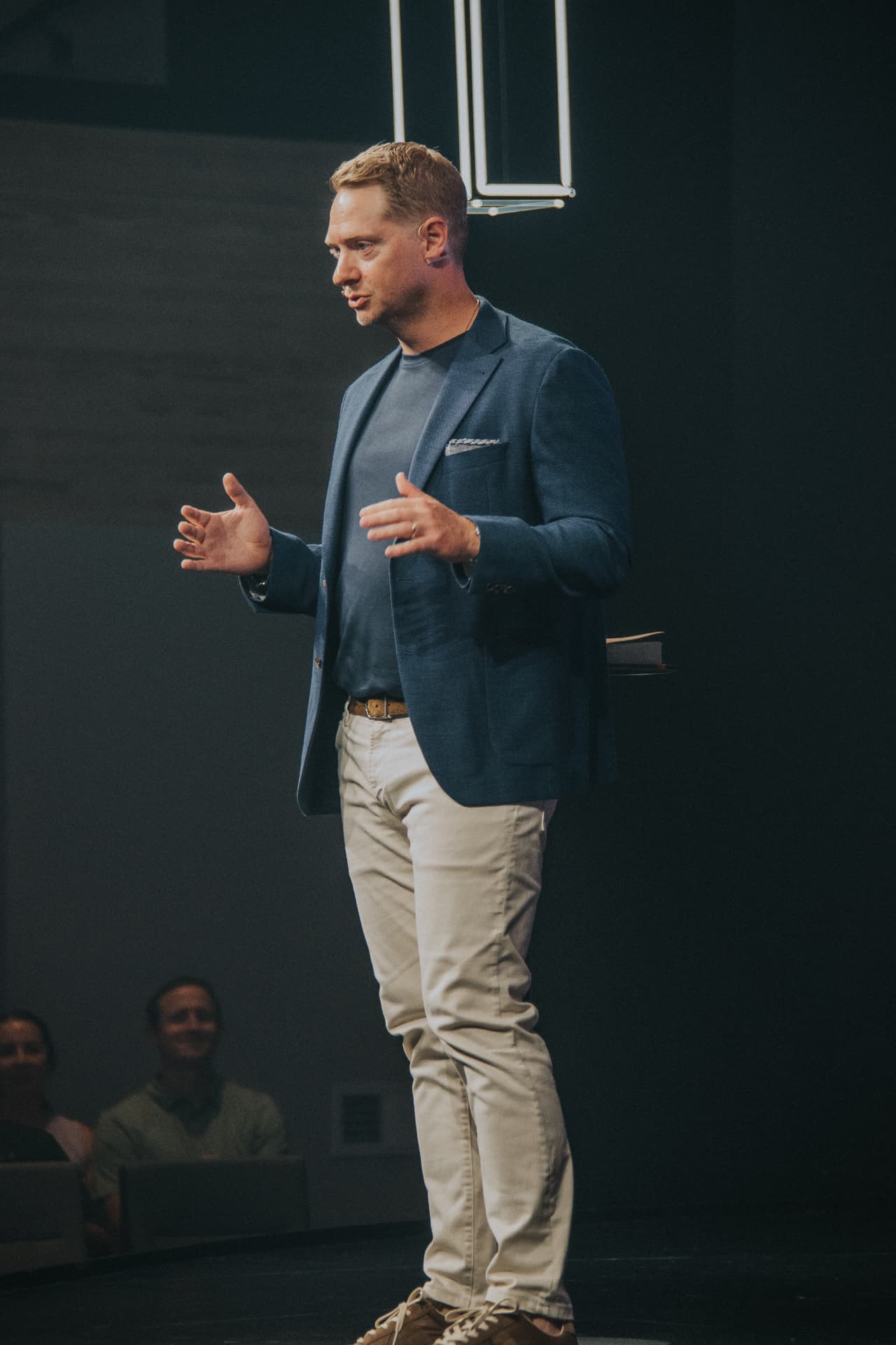 Jason VanRuler speaking on stage to a live audience